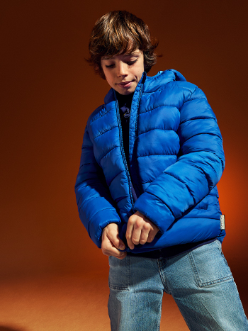 Bambino vestito con giacca blu e jeans alla moda